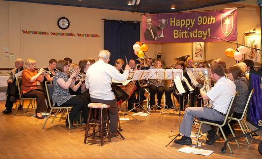 Mr Eccles conducts the band at his 90th birthday party